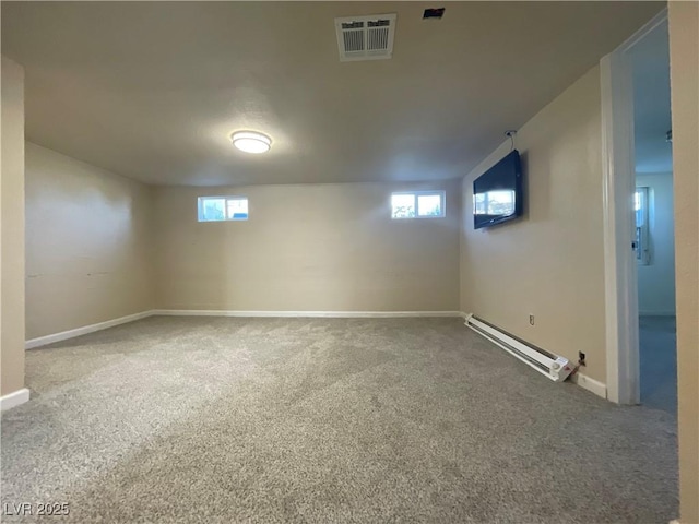 basement featuring a baseboard heating unit and carpet floors