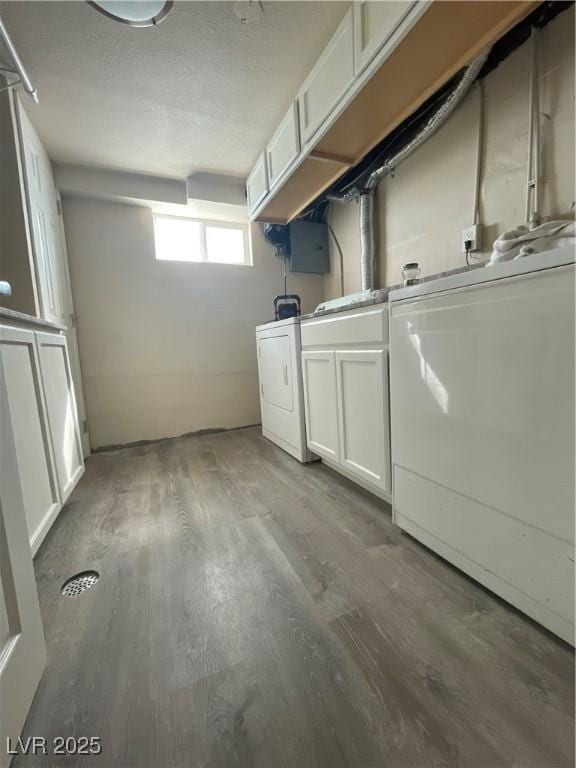 laundry area with washer / dryer, cabinets, and dark hardwood / wood-style flooring