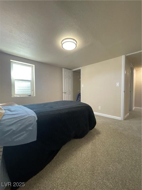 carpeted bedroom featuring a textured ceiling