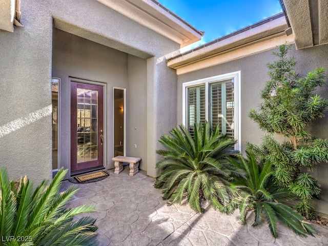 property entrance featuring a patio