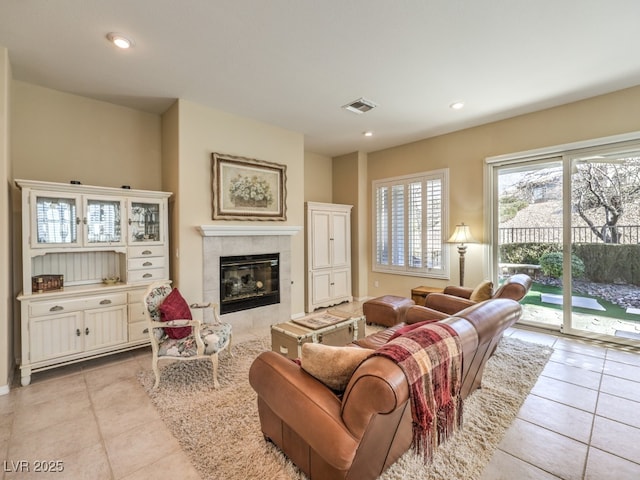 living room with light tile patterned flooring and a fireplace