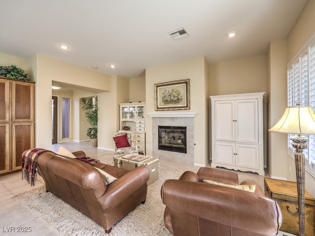 living room with a tiled fireplace