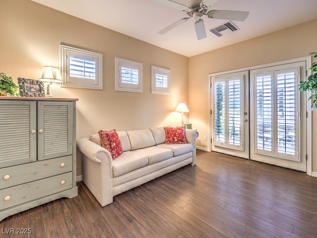 living room with ceiling fan and dark hardwood / wood-style floors