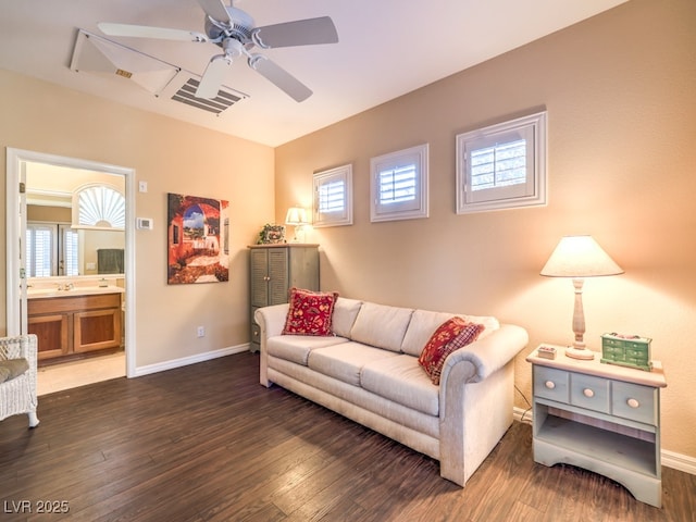 living room featuring ceiling fan and dark hardwood / wood-style floors