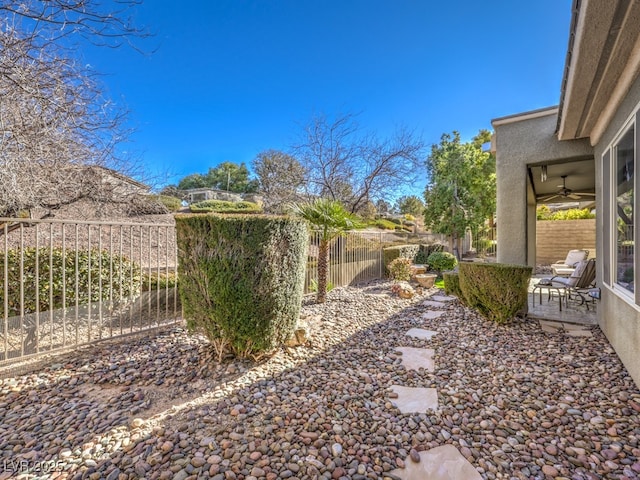 view of yard with a patio area and ceiling fan