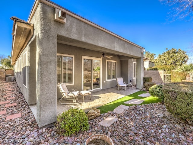 rear view of property with a patio area and ceiling fan