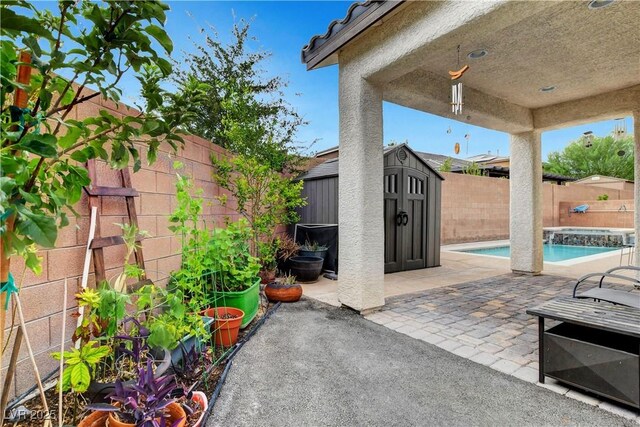 view of patio / terrace with a fenced in pool and a shed