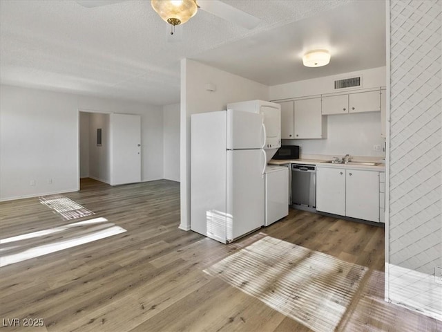 kitchen featuring white refrigerator, dishwasher, dark hardwood / wood-style floors, and white cabinetry