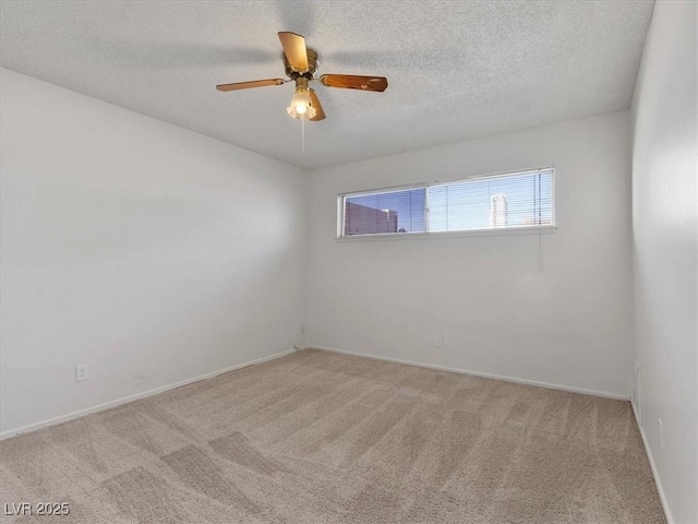 unfurnished room with a textured ceiling, light carpet, and ceiling fan