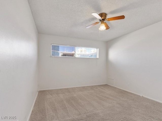 carpeted empty room with a textured ceiling and ceiling fan