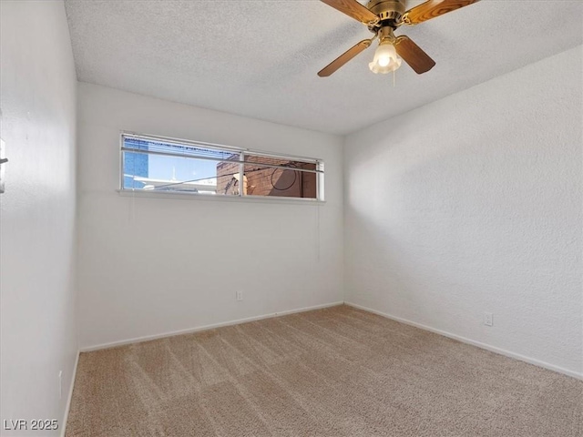 empty room with ceiling fan, a textured ceiling, and carpet flooring