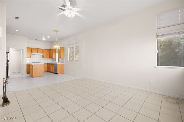 kitchen with stainless steel dishwasher, hanging light fixtures, backsplash, light tile patterned flooring, and ceiling fan