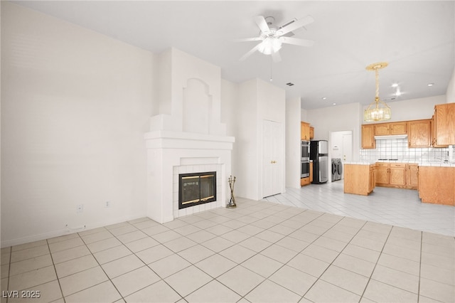 unfurnished living room with light tile patterned flooring, ceiling fan, and a tiled fireplace