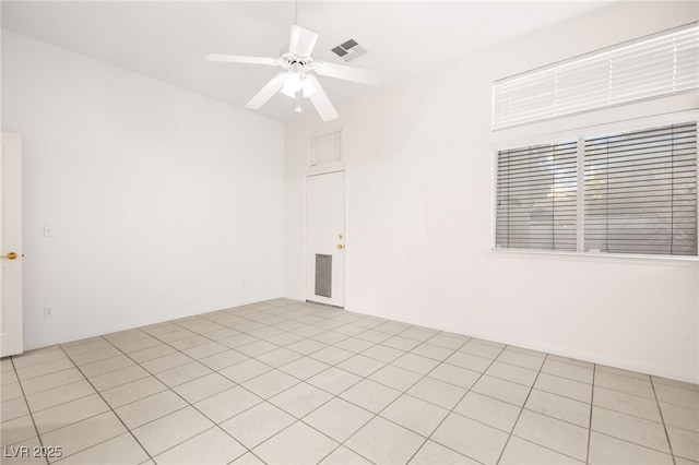 empty room featuring light tile patterned flooring and ceiling fan