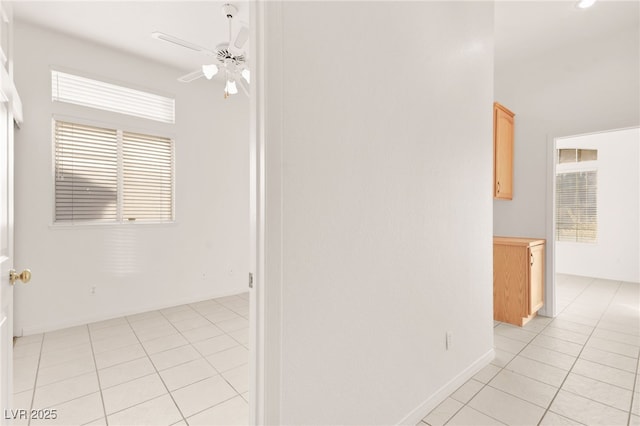 hall with light tile patterned floors