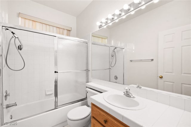 full bathroom with toilet, combined bath / shower with glass door, and vanity