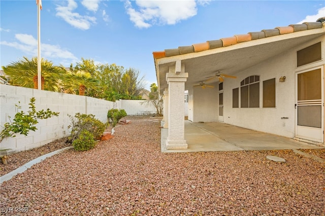 view of yard featuring a patio area and ceiling fan