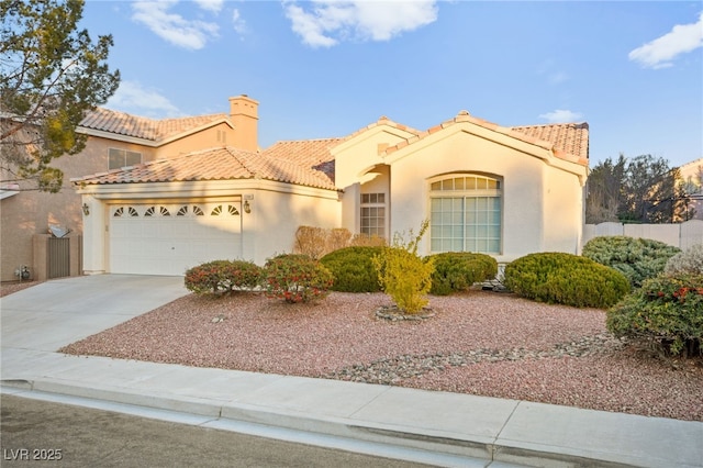 mediterranean / spanish house featuring a garage