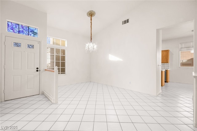 interior space featuring light tile patterned floors and a notable chandelier