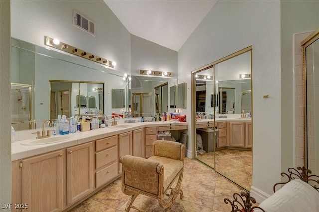 bathroom with high vaulted ceiling, an enclosed shower, and vanity