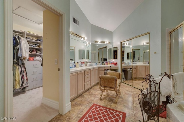 bathroom with lofted ceiling and vanity