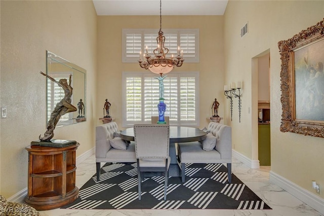 dining area featuring a notable chandelier