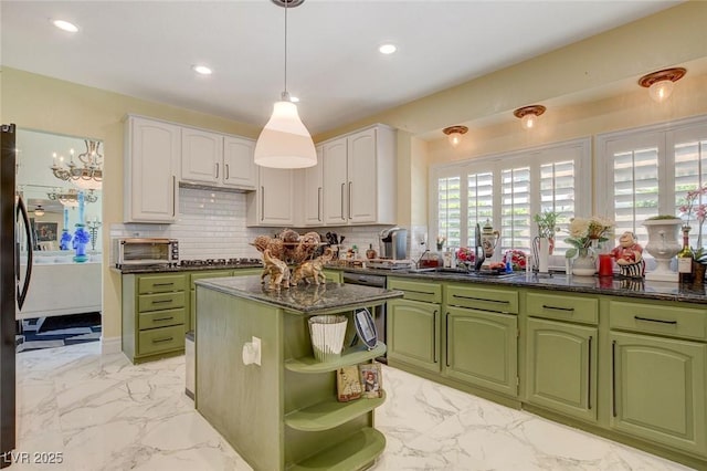 kitchen with decorative backsplash, white cabinetry, pendant lighting, and a center island