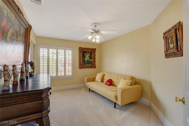 living area with ceiling fan and light carpet