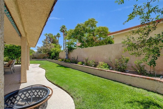 view of yard featuring a fire pit and a patio area