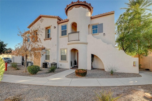 mediterranean / spanish-style house featuring a balcony and central AC unit