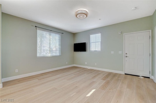 unfurnished living room with plenty of natural light and light hardwood / wood-style flooring