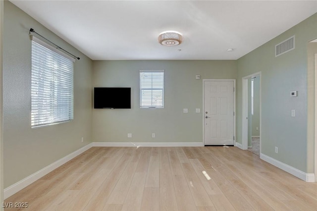 spare room featuring light hardwood / wood-style floors