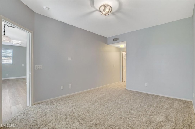 empty room featuring light carpet