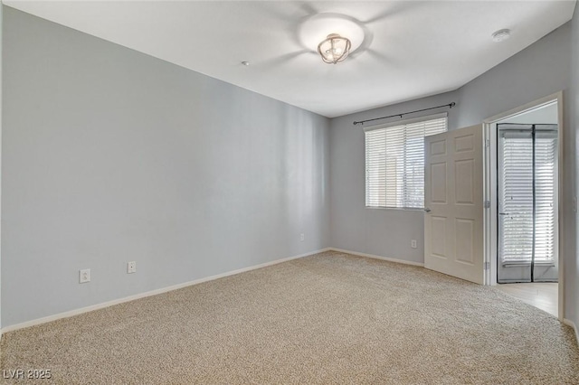 spare room featuring light carpet