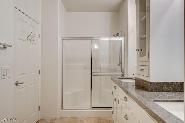 bathroom featuring walk in shower and vanity