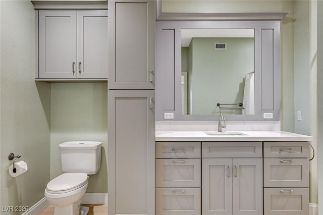 bathroom with toilet and vanity