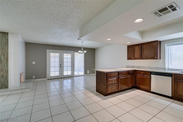 kitchen with pendant lighting, dishwasher, kitchen peninsula, and light tile patterned floors