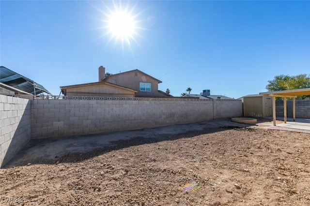 view of yard with a patio area and a storage shed