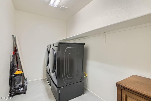 laundry area featuring independent washer and dryer and light tile patterned floors