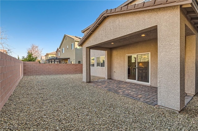 rear view of property featuring a patio area