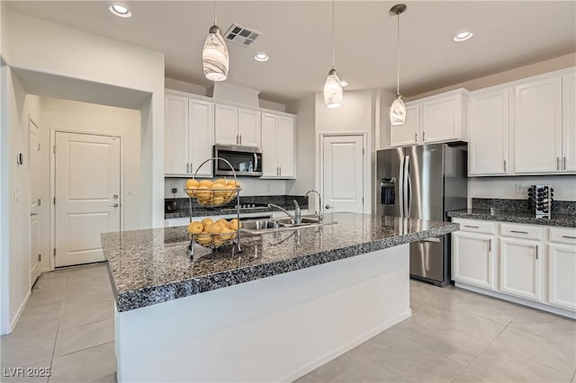 kitchen featuring sink, a center island with sink, white cabinetry, and appliances with stainless steel finishes