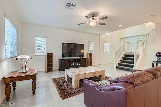 tiled living room with ceiling fan