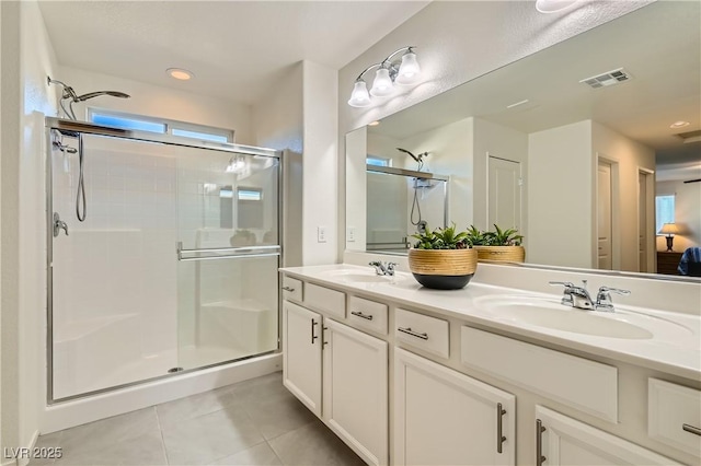 bathroom with walk in shower, tile patterned floors, and vanity