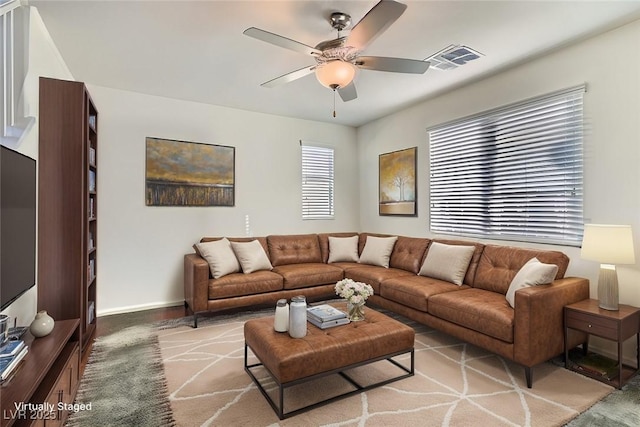 living room with ceiling fan and carpet flooring