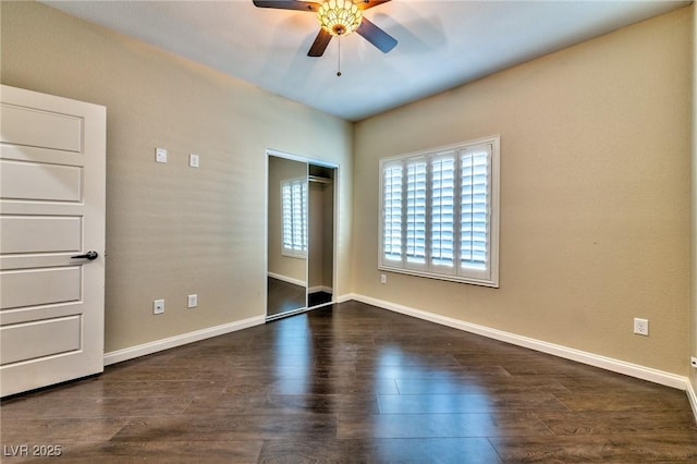 unfurnished bedroom with ceiling fan, a closet, and dark hardwood / wood-style floors