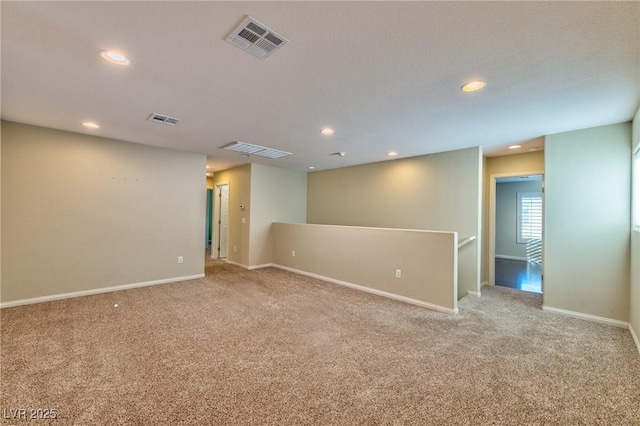 empty room with light colored carpet