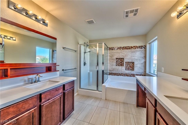 bathroom with plus walk in shower, vanity, and plenty of natural light