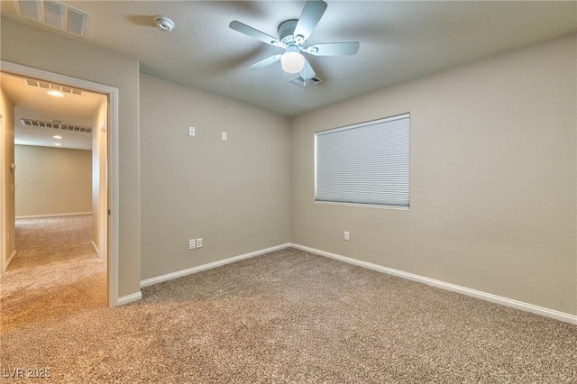 carpeted spare room featuring ceiling fan