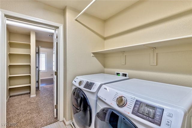 laundry room featuring washing machine and clothes dryer and light carpet