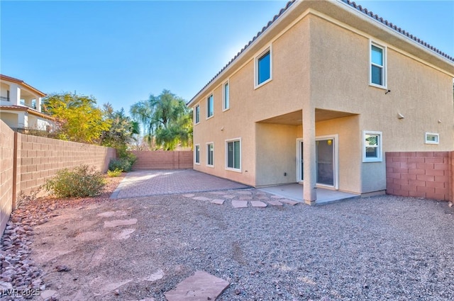 back of property featuring a patio